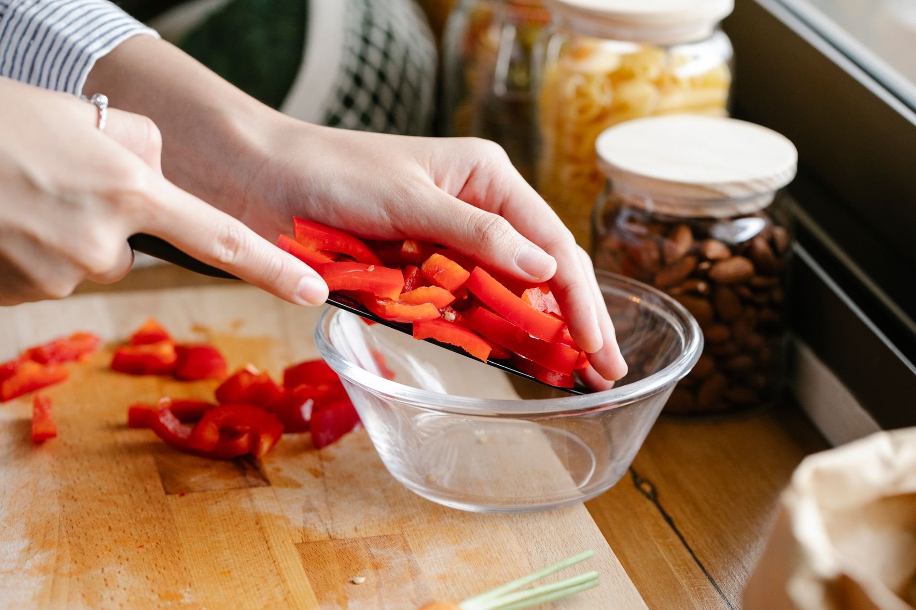 Cook carefully preparing red peppers — the same hands-on craft that goes into every Fierro Fire batch